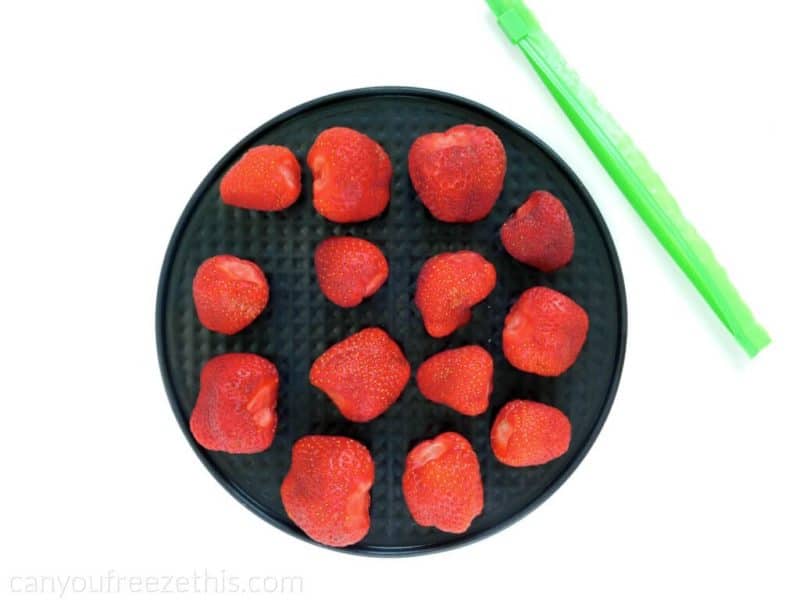 Frozen strawberries on a cookie sheet