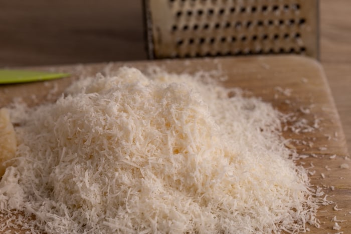 Grated defrosted parmesan block
