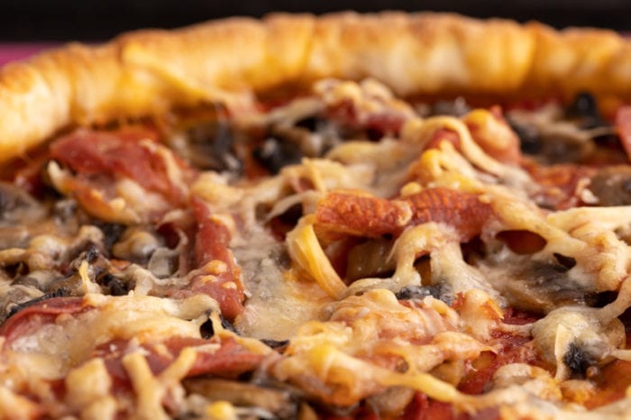 Pizza with shredded cheese
